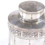 A Liberty & Co oval silver tea caddy, with relief embossed Arts and Crafts fruit designs,