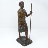 A patinated spelter figure of an Arab man carrying a water flagon, signed on the base, circa 1900,