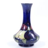 A Moorcroft blue ground Wisteria pattern narrow-necked vase, height 15cm