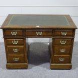 A Victorian oak pedestal desk, with green leather top and brass drop handles, 3'6" x 2'