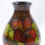A Moorcroft flambe Hibiscus pattern vase, original label under base, height 21cm