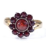 An 18ct gold faceted garnet cluster ring, setting height 13.4mm, size S, 3.3g