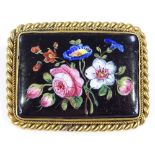 A rectangular floral painted porcelain panel brooch, in unmarked yellow metal rope twist frame,