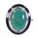 An Art Deco sterling silver green stone and black enamel panel ring, with pierced settings and