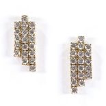 A pair of unmarked gold triple-row diamond earrings, each set with 19 round brilliant-cut