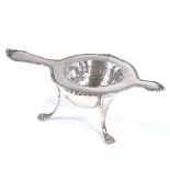 A Danish silver tea strainer, with threaded rim, length 14.5cm, together with a similar silver