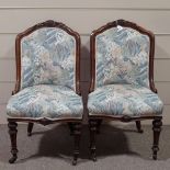 A pair of Victorian carved walnut-framed upholstered chairs