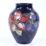 A Moorcroft blue ground Anemone pattern vase, height 12cm