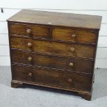 A George III oak square chest of 3 long and 2 short drawers, with turned handles and bracket feet,