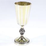 A Swedish silver-gilt goblet, with hand planished finish and pierced globe stem, by Erik Lofman,