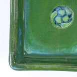 A Moorcroft Flamminian Ware square bowl, with green glaze and stylised central panel, 24cm across