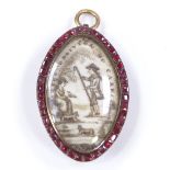 A Georgian unmarked gold garnet and ivory memorial pendant, depicting shepherd and lady with