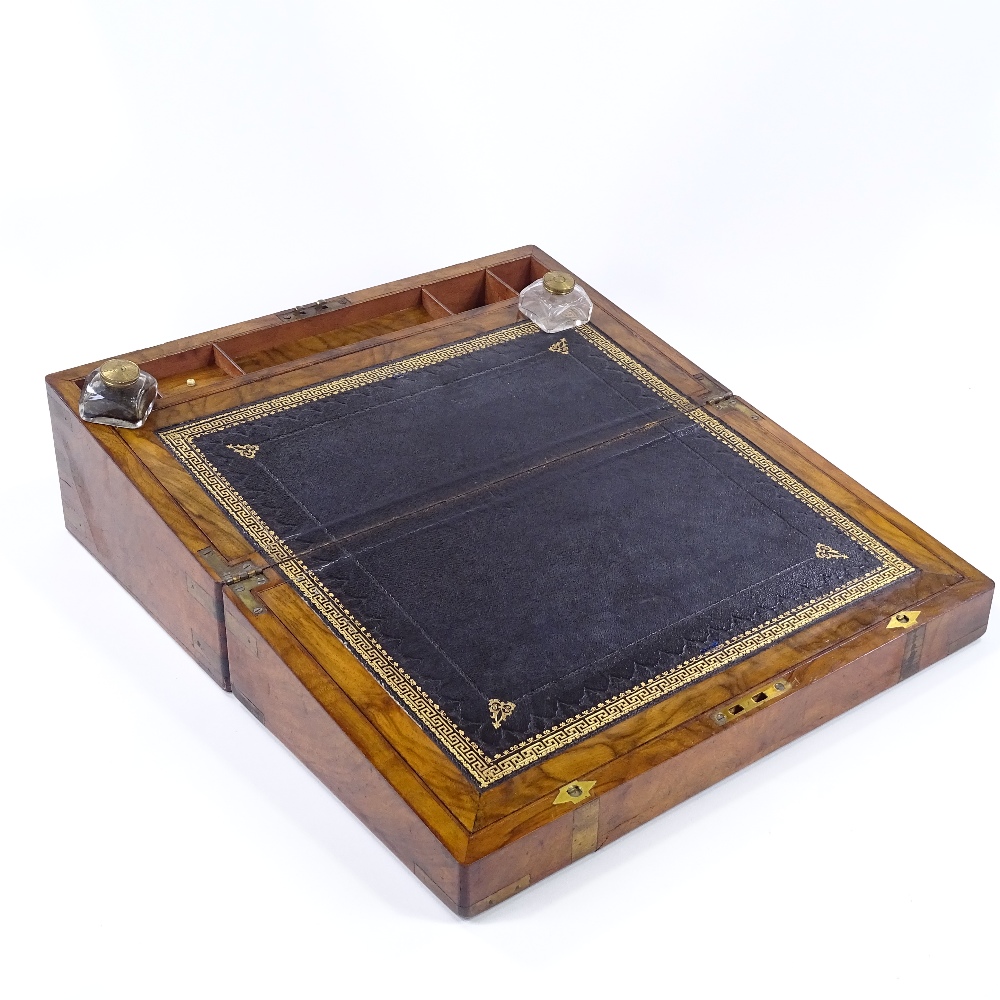 A Victorian brass-bound walnut writing slope, with fitted interior and original inkwells, width 45cm