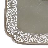 A square silver cake stand, with pierced floral border, on pedestal base, by Frank Cobb & Co Ltd,