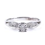 A 9ct white gold solitaire diamond ring, with diamond set shoulders, total diamond content approx