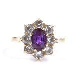 An 18ct gold amethyst and diamond cluster ring, total diamond content approx 0.8ct, setting height
