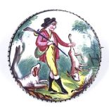 A late Georgian painted enamel hunting brooch, depicting game hunter with dog, unmarked silver