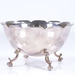 An American sterling silver bowl, with fluted frilled rim, on foliate claw and ball feet, by William