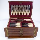 A canteen of plated cutlery and servers for 12 people, with ivory handles, circa 1900, in oak