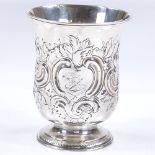 An early 19th century silver fluted beaker, with relief embossed foliate and floral decoration,