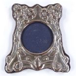 A modern silver-fronted photo frame, with relief embossed floral decoration, hallmarks London