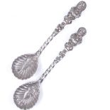 A pair of Victorian novelty silver salt spoons, with cast figure handles and shell bowls, by