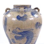 A Chinese crackle glaze blue and white porcelain dragon jar with neck-ring handles, height 30cm