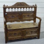 A Victorian light oak hall settle with carved and panelled Arcadian back, length 3'11"