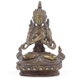 An Oriental patinated bronze seated deity, height 15cm