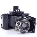 A Zeiss Ikon Super Ikonta folding camera, leather-cased