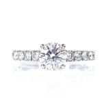 De Beers - a 1ct solitaire diamond ring with diamond set shoulders, total diamond content approx