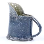 Walter Keeler (British born 1942), a blue salt glaze leaning jug, height 16cm