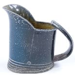 Walter Keeler (British born 1942), a blue salt glaze leaning jug, height 18cm, hairline crack