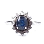 An 18ct white gold sapphire and diamond cluster ring, oval-cut sapphire approx 0.71ct, setting