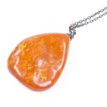 A large butterscotch amber pendant necklace, maker's marks DHAE, pendant height 49.1mm, chain length