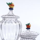 2 similar Continental hand blown glass sweet meat jars with coloured glass fruit finials, largest