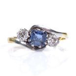 An 18ct gold 3-stone sapphire and diamond crossover ring, total diamond content approx 0.1ct,