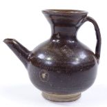 A Chinese dark brown glaze jar with spout, height 11cm