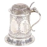 A George V miniature silver tankard, with relief embossed floral decoration and engraved golfing
