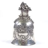 A Continental silver hand bell, with relief embossed foliate decoration, height 10cm