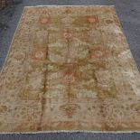 A 20th century cream hand knotted Chobi rug, with floral pattern and border, 282cm x 216cm