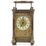 An ornate French brass-cased carriage clock with fretwork decoration, height 13cm