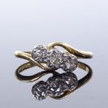 An 18ct gold 3-stone diamond crossover ring, total diamond content approx 0.15ct, setting height 6.
