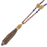 An Oriental string of carved and polished vegetable ivory and stained wood bead sautoir necklace,