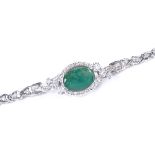 A 14ct white gold emerald and diamond cluster bracelet, oval-cut emerald approx 3.2ct, total diamond
