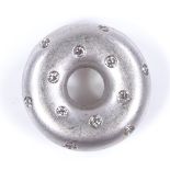 A 14ct white gold diamond set doughnut pendant, with openwork pierced heart-shaped settings, pendant