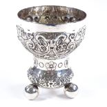 A Continental silver goblet, with relief embossed floral decoration, marks to base, height 10cm, 4oz