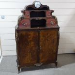 An 18th century French kingwood and marquetry inlaid side cabinet, with inset clock to the pediment,