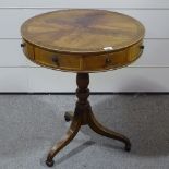 A small mahogany drum-top occasional table, with frieze drawers on tripod base, 24" across