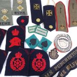 A collection of military cloth badges, epaulettes etc, including Navy cap bands from HMS Belfast,